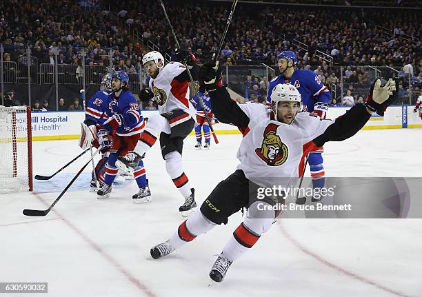 Zack Smith of the Ottawa Senators scores at 3:10 of the first period against Antti Raanta of the New York Rangers as Derick Brassard joins the...