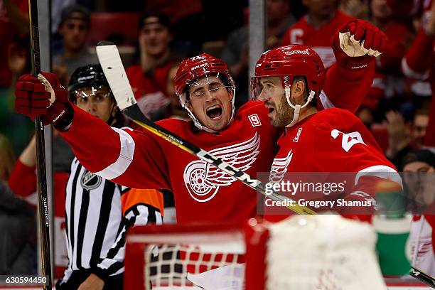 Drew Miller of the Detroit Red Wings celebrates a second-period goal with teammate Dylan Larkin while playing the Buffalo Sabres at Joe Louis Arena...