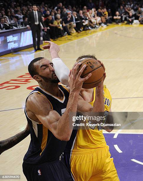 Rudy Gobert of the Utah Jazz gets an elbow from Timofey Mozgov of the Los Angeles Lakers during the first half of the basketball game at Staples...