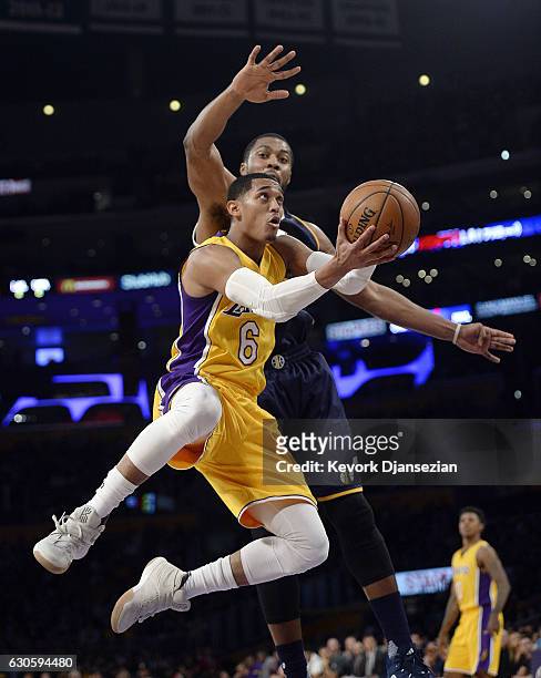 Jordan Clarkson of the Los Angeles Lakers scores against Derrick Favors of the Utah Jazz during the first half half of the basketball game at Staples...