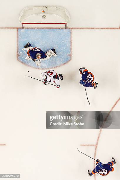 Jaroslav Halak of the New York Islanders makes a save against Justin Williams of the Washington Capitals at the Barclays Center on December 27, 2016...