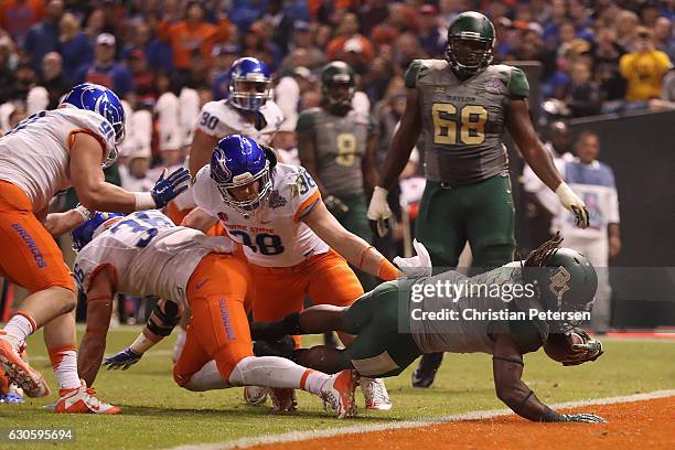 Running back JaMycal Hasty of the Baylor Bears dives into the end zone to score on a five yard touchdown rush against the Boise State Broncos during...