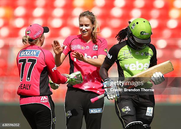 Ellyse Perry of the Sixers celebrates with team mate Alyssa Healy after claiming the wicket of Stafanie Taylor of the Thunder during the WBBL match...