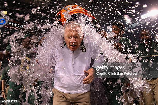 Head coach Jim Grobe of the Baylor Bears is dunked with gatorade following the Motel 6 Cactus Bowl against the Boise State Broncos at Chase Field on...