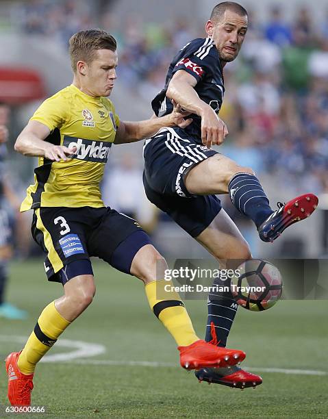 Scott Galloway of Central Coast Mariners and Carl Valeri of Melbourne Victory compete during the round 12 A-League match between Melbourne Victory...