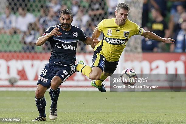 Ben Khalfallah of the Victory challenges Nick Montgomery of Central Coast Mariners during the round 12 A-League match between Melbourne Victory and...