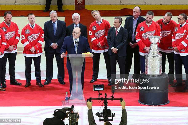 Former head coach Scotty Bowman, with members of the 1996-1997 team in the background, speaks to the crowd during the 20th anniversary of the 1997...