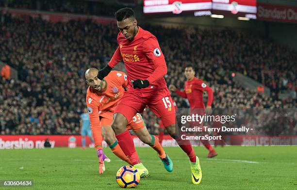 Liverpool's Daniel Sturridge goes around Stoke City's goalkeeper Lee Grant to score his sides fourth goal during the Premier League match between...