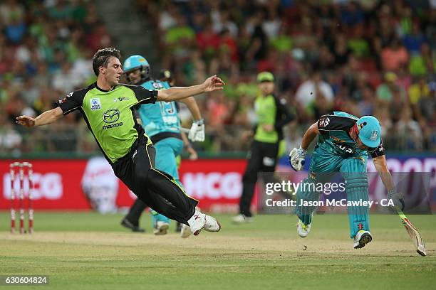 Pat Cummins of the Thunder attempts to run out Chris Lynn during the Big Bash League match between the Sydney Thunder and Brisbane Heat at Spotless...