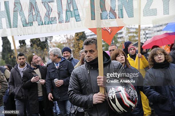 Members of the POE-OTA trade union hold banners during a protest against disemployment in Athens, Greece on December 28, 2016.