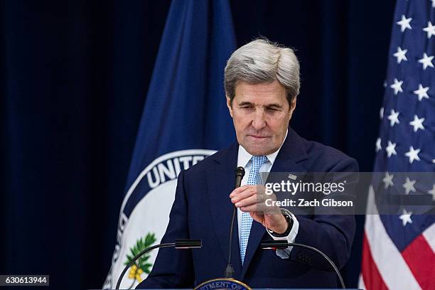 Secretary of State John Kerry adjusts his microphone before delivering a speech on Middle East peace at The U.S. Department of State on December 28,...