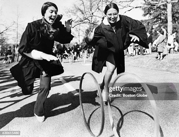 Wellesley College seniors raced hoop and hoop down the lane in Wellesley, Mass., on April 27, 1974. The college has held a hoop rolling race in...
