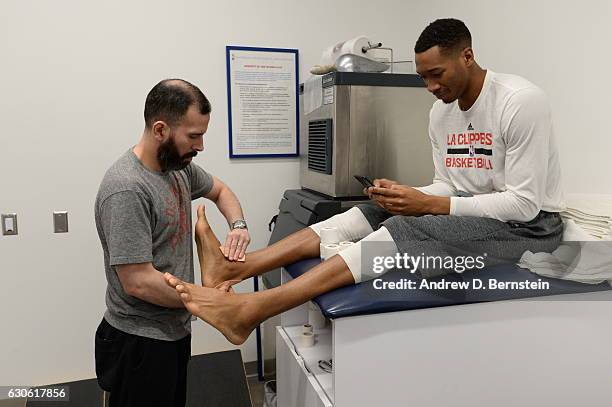 Wesley Johnson of the LA Clippers gets treatment before the game against the Los Angeles Lakers on December 25, 2016 at STAPLES Center in Los...