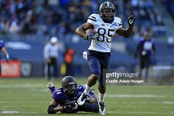 Jester Weah of the Pittsburgh Panthers breaks a tackle by cornerback Montre Hartage of the Northwestern Wildcats on his way to scoring a touchdown...