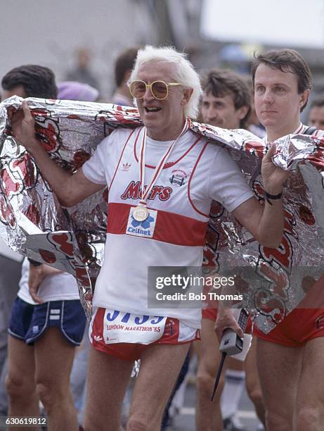 Television personality Jimmy Savile completes the London Marathon on 21st April 1985.