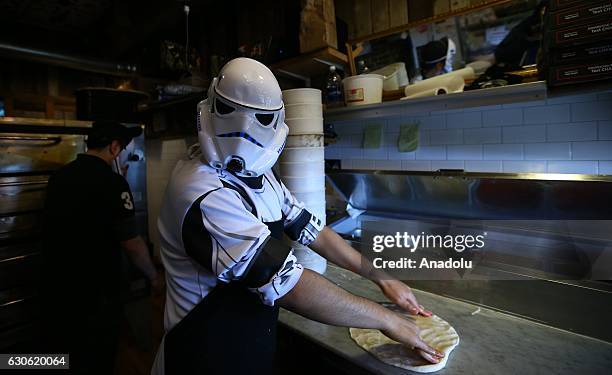 Turkish oriented pizza restaurant-chain owner and a three-time World Pizza Spinning Champion Hakki Akdeniz prepares a pizza to distribute free pizza...