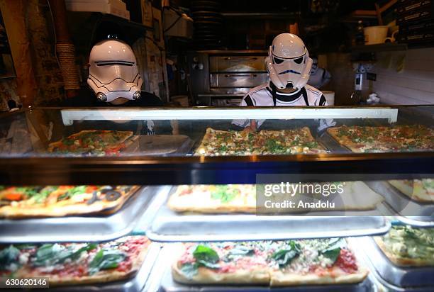 People, dressed with Star Wars movie character costumes pose as Turkish oriented pizza restaurant-chain owner and a three-time World Pizza Spinning...