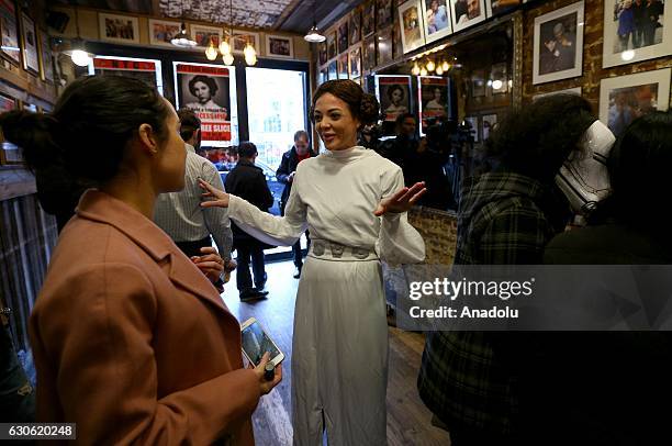 Customer, dressed as Star Wars movie character Princess Leia, is seen as Turkish oriented pizza restaurant-chain owner and a three-time World Pizza...