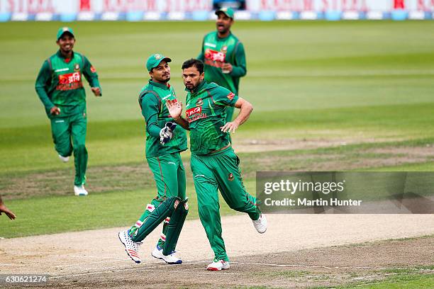 Mashrafe Mortaza of Bangladesh celebrates the wicket of Martin Guptill of New Zealand during the second One Day International match between New...