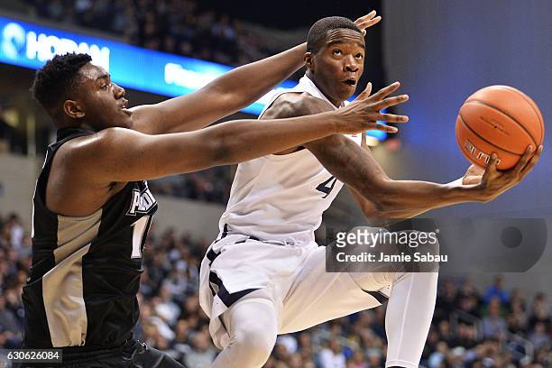Edmond Sumner of the Xavier Musketeers lays in for two points while being fouled by Kalif Young of the Providence Friars in the second half on...