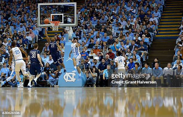 Austin Tilghman of the Monmouth Hawks drives to the basket against Luke Maye of the North Carolina Tar Heels during the game at the Dean Smith Center...
