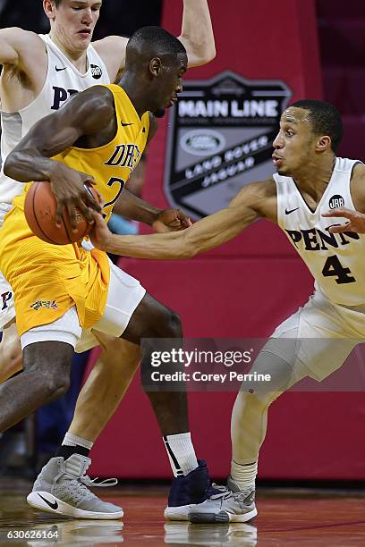 Darnell Foreman of the Pennsylvania Quakers steals the ball from Rodney Williams of the Drexel Dragons as this play would stop the Dragons' momentum...