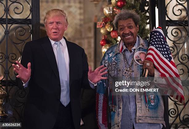 President-elect Donald Trump, along with boxing promoter Don King, answers questions from the media after a day of meetings on December 28, 2016 at...