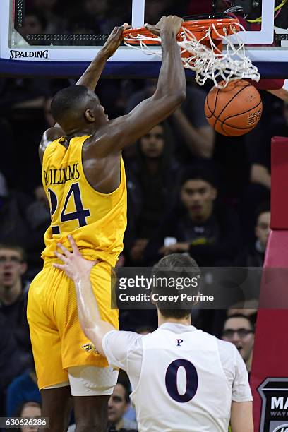 Rodney Williams of the Drexel Dragons shows down a dunk against Max Rothschild of the Pennsylvania Quakers during the second half at The Palestra on...