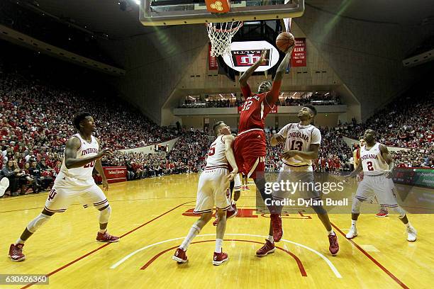 Jordy Tshimanga of the Nebraska Cornhuskers attempts a layup over Zach McRoberts of the Indiana Hoosiers in the first half at Assembly Hall on...