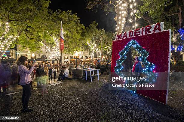 One girl take a picture in the Christmas city lights on December 29, 2016 in Funchal, Madeira, Portugal.