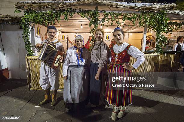 Four persons with the Madeira Island traditional costume poses for the picture in the city during Christmas celebrations on December 29, 2016 in...