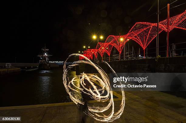Woman dancing with fire on December 29, 2016 in Funchal, Madeira, Portugal.
