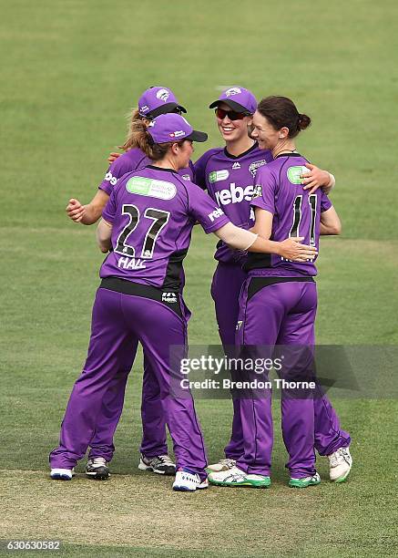 Julie Hunter of the Hurricanes celebrates with team mates after claiming the wicket of Alyssa Healy of the Sixers during the WBBL match between the...