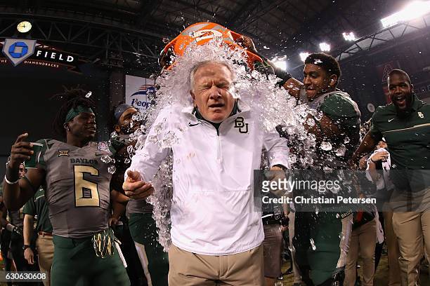 Head coach Jim Grobe of the Baylor Bears is dunked with gatorade following the Motel 6 Cactus Bowl against the Boise State Broncos at Chase Field on...