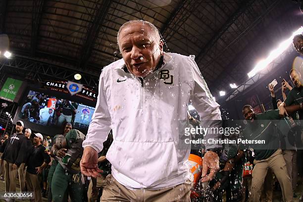 Head coach Jim Grobe of the Baylor Bears reacts after being dunked with gatorade following the Motel 6 Cactus Bowl against the Boise State Broncos at...