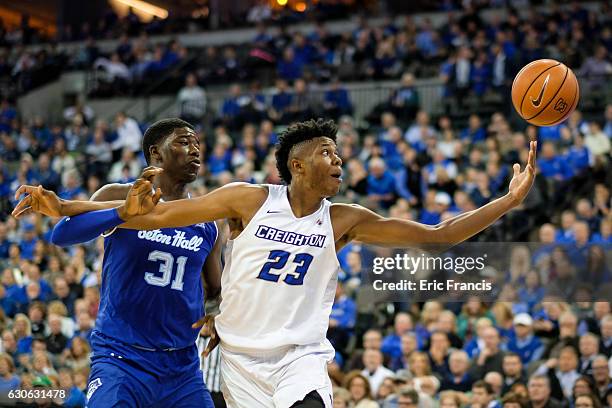 Justin Patton of the Creighton Bluejays reaches for the ball while being guarded by Angel Delgado of the Seton Hall Pirates during their game at the...