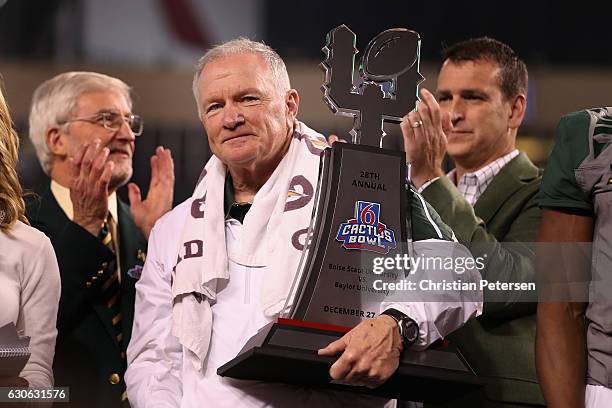 Head coach Jim Grobe of the Baylor Bears celebrates with the trophy following the Motel 6 Cactus Bowl against the Boise State Broncos at Chase Field...