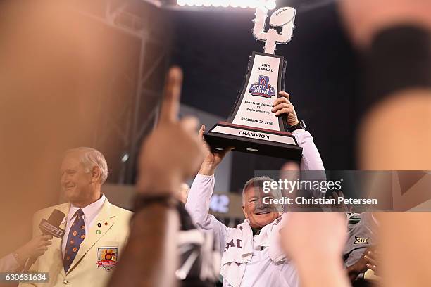 Head coach Jim Grobe of the Baylor Bears celebrates with the trophy following the Motel 6 Cactus Bowl against the Boise State Broncos at Chase Field...