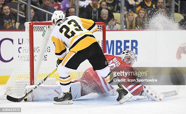 Scott Wilson of the Pittsburgh Penguins is stopped on a breakaway by Cam Ward of the Carolina Hurricanes in the second period during the game between...
