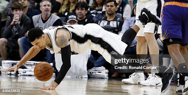 Danny Green of the San Antonio Spurs falls as he is fouled by a Phoenix Sun player at AT&T Center on December 14, 2016 in San Antonio, Texas. NOTE TO...