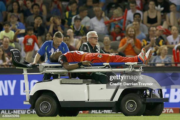 Dwayne Bravo of the Melbourne Renegades is taken from the ground on a stretcher after injuring himself in the field during the Big Bash League match...