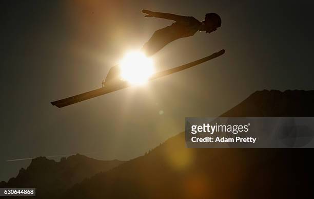 Lukas Hlava of Czech Republic soars through the air during his training jump on Day 1 of the 65th Four Hills Tournament ski jumping event on December...