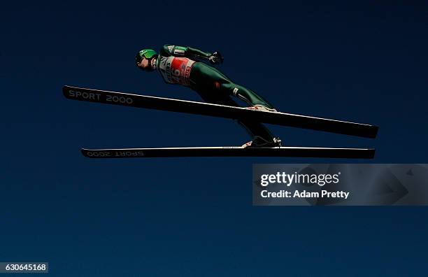 Jurij Tepes of Slovenia soars through the air during his training jump on Day 1 of the 65th Four Hills Tournament ski jumping event on December 29,...