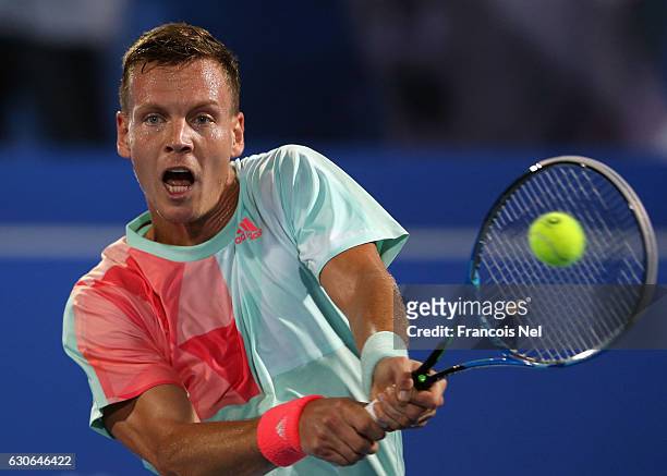 Tomas Berdych of the Czech Republic plays a backhand against Rafeal Nadal of Spain during day one of the Mubadala World Tennis Championship at Zayed...