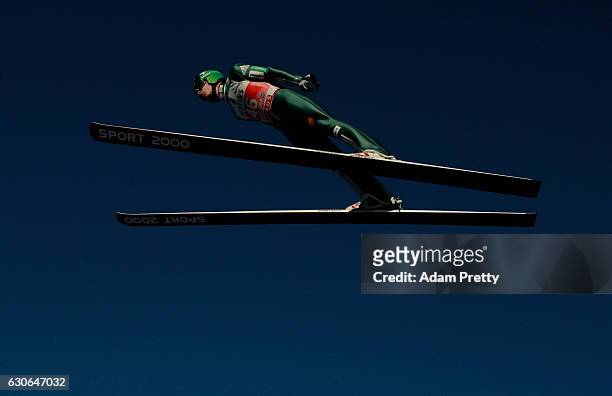 Jurij Tepes of Slovenia soars through the air during his training jump on Day 1 of the 65th Four Hills Tournament ski jumping event on December 29,...