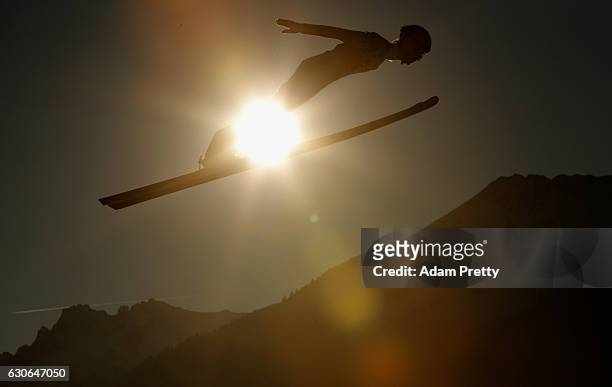 Lukas Hlava of Czech Republic soars through the air during his training jump on Day 1 of the 65th Four Hills Tournament ski jumping event on December...