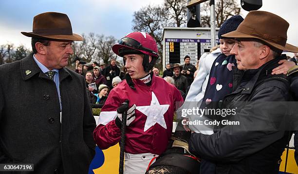 Dublin , Ireland - 29 December 2016; Jockey Bryan Cooper in conversation with racing manager Eddie O'Leary, left, and owner Michael O'Leary, holding...