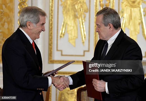 Piotr Glinski , Poland's deputy Prime Minister and culture minister, and Adam Karol Czartoryski, owner of a large private art collection shake hands...