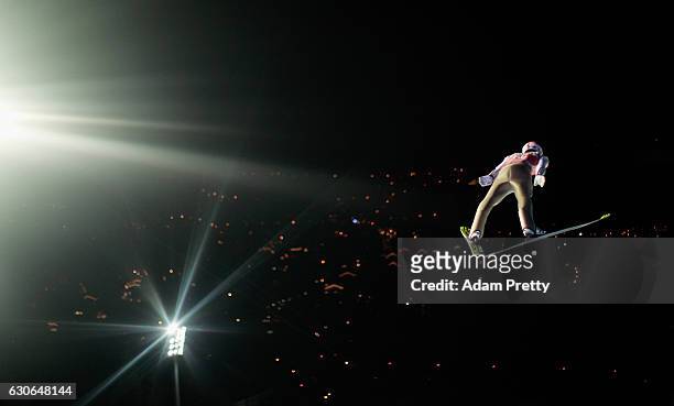 Severin Freund of Germany soars through the air during his qualification jump on Day 1 of the 65th Four Hills Tournament ski jumping event on...