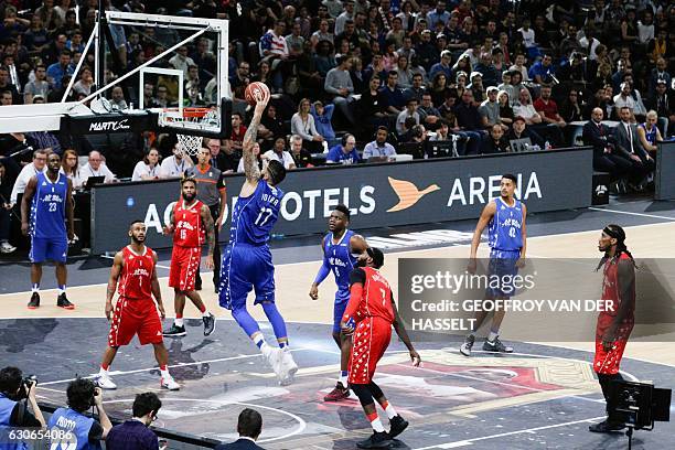 France's Vincent Poirier scores during an All Star Game basketball match of the French Ligue Nationale de Basket between a selection of the best...